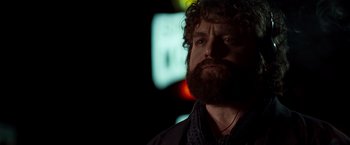 Movie still from “Due Date” (2010), directed by Todd Phillips – A man with a beard is looking into the distance; Close Up shot, Over the shoulder angle