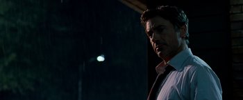 Movie still from “Due Date” (2010), directed by Todd Phillips – A person wearing a shirt and tie; Close Up shot, Over the shoulder angle