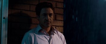 Movie still from “Due Date” (2010), directed by Todd Phillips – A person standing near a brick wall; Close Up shot, Over the shoulder angle