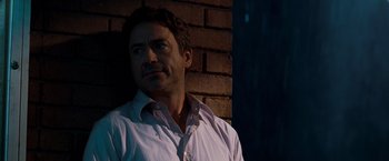 Movie still from “Due Date” (2010), directed by Todd Phillips – A person standing near a brick wall; Close Up shot, Over the shoulder angle