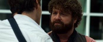 Movie still from “Due Date” (2010), directed by Todd Phillips – A man with a beard is talking to another man; Close Up shot, Over the shoulder angle