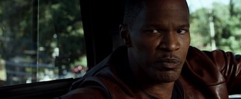 Movie still from “Due Date” (2010), directed by Todd Phillips – A person wearing a leather jacket; Close Up shot, Over the shoulder angle