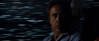 Movie still from “Due Date” (2010), directed by Todd Phillips – A person in a dark room; Close Up shot, Low angle