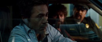Movie still from “Due Date” (2010), directed by Todd Phillips – A person sitting in a car; Close Up shot, Over the shoulder angle