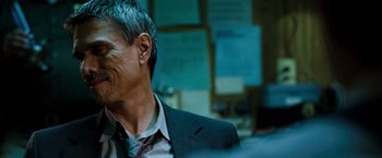 Movie still from “Due Date” (2010), directed by Todd Phillips – A person wearing a suit and tie; Close Up shot, Over the shoulder angle