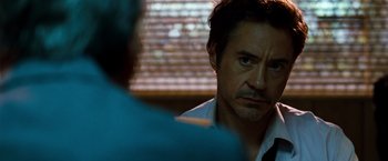 Movie still from “Due Date” (2010), directed by Todd Phillips – A person sitting in front of another person; Close Up shot, Over the shoulder angle