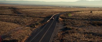 Movie still from “Due Date” (2010), directed by Todd Phillips – An aerial view of a truck driving down a road; Extreme Wide shot, High angle