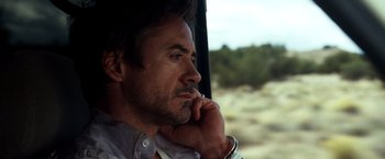 Movie still from “Due Date” (2010), directed by Todd Phillips – A person sitting in a car; Close Up shot, Low angle