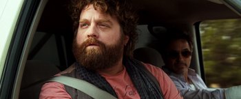 Movie still from “Due Date” (2010), directed by Todd Phillips – A person sitting in a car; Close Up shot, Low angle