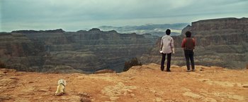 Movie still from “Due Date” (2010), directed by Todd Phillips – A man standing on top of a mountain looking at the sky; Extreme Wide shot, High angle