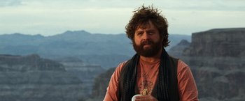 Movie still from “Due Date” (2010), directed by Todd Phillips – A man with a beard is holding a cup; Close Up shot, Over the shoulder angle