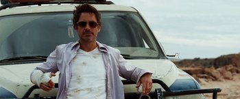 Movie still from “Due Date” (2010), directed by Todd Phillips – A man in sunglasses leaning against a car; Close Up shot, Low angle