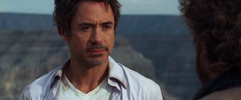 Movie still from “Due Date” (2010), directed by Todd Phillips – A person wearing a white shirt; Close Up shot, Over the shoulder angle