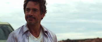 Movie still from “Due Date” (2010), directed by Todd Phillips – A person wearing a white shirt; Close Up shot, Over the shoulder angle