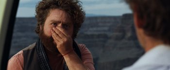 Movie still from “Due Date” (2010), directed by Todd Phillips – A man covering his mouth with his hands; Close Up shot, Over the shoulder angle