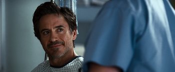 Movie still from “Due Date” (2010), directed by Todd Phillips – A person wearing a hospital gown; Close Up shot, Over the shoulder angle