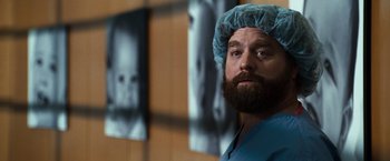 Movie still from “Due Date” (2010), directed by Todd Phillips – A man with a beard wearing a surgical cap; Close Up shot, Low angle
