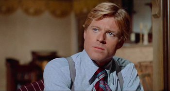 Movie still from “The Sting” (1973), directed by George Roy Hill – A person wearing a shirt and a tie; Close Up shot, Low angle
