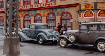 Movie still from “The Sting” (1973), directed by George Roy Hill – An old car parked in front of a building; Wide shot, High angle