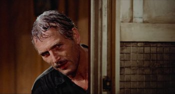 Movie still from “The Sting” (1973), directed by George Roy Hill – A person standing in front of a door; Close Up shot, Over the shoulder angle