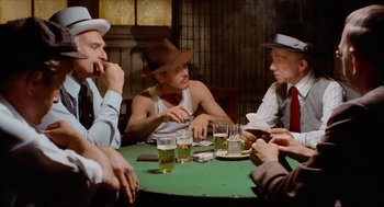 Movie still from “The Sting” (1973), directed by George Roy Hill – A group of men sitting at a table with drinks; Medium shot, High angle
