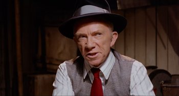 Movie still from “The Sting” (1973), directed by George Roy Hill – An older man wearing a hat and a tie; Close Up shot, High angle