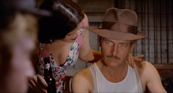 Movie still from “The Sting” (1973), directed by George Roy Hill – A man and a woman with a hat and a beer; Close Up shot, Over the shoulder angle