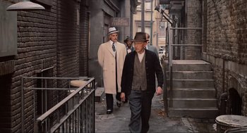 Movie still from “The Sting” (1973), directed by George Roy Hill – A group of men walking down a sidewalk; Wide shot, Over the shoulder angle