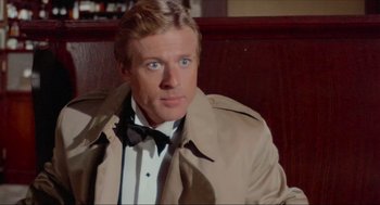 Movie still from “The Sting” (1973), directed by George Roy Hill – A person wearing a jacket and bow tie; Close Up shot, Over the shoulder angle