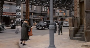 Movie still from “The Sting” (1973), directed by George Roy Hill – An older woman is walking down the street; Wide shot, High angle