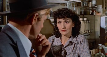 Movie still from “The Sting” (1973), directed by George Roy Hill – A man and a woman looking at one another; Close Up shot, Over the shoulder angle