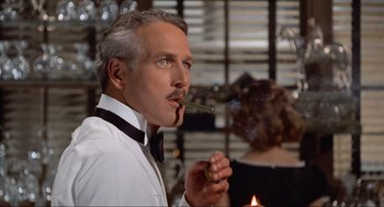 Movie still from “The Sting” (1973), directed by George Roy Hill – A man in a tuxedo smoking a cigarette; Close Up shot, Over the shoulder angle