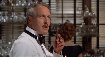 Movie still from “The Sting” (1973), directed by George Roy Hill – A man that is holding a cigarette in his hand; Close Up shot, Over the shoulder angle