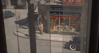 Movie still from “The Sting” (1973), directed by George Roy Hill – An old photo of a man walking down the street; Extreme Wide shot, High angle
