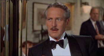 Movie still from “The Sting” (1973), directed by George Roy Hill – A man in a suit and bow tie; Close Up shot, Over the shoulder angle