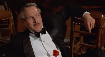 Movie still from “The Sting” (1973), directed by George Roy Hill – A person wearing a suit and tie; Close Up shot, High angle