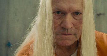 Movie still from “The Suicide Squad” (2021), directed by James Gunn – An old man with long white hair and blue eyes; Close Up shot, Low angle