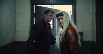 Movie still from “The Suicide Squad” (2021), directed by James Gunn – A man and a man with long white hair; Medium shot, Over the shoulder angle