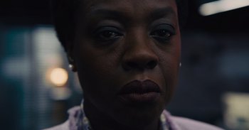 Movie still from “The Suicide Squad” (2021), directed by James Gunn – A woman's face in a dark room; Close Up shot, Low angle