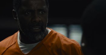 Movie still from “The Suicide Squad” (2021), directed by James Gunn – A person wearing an orange shirt; Close Up shot, Over the shoulder angle