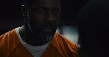 Movie still from “The Suicide Squad” (2021), directed by James Gunn – A person wearing an orange shirt; Close Up shot, Over the shoulder angle
