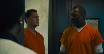 Movie still from “The Suicide Squad” (2021), directed by James Gunn – A couple of men standing next to each other; Medium shot, Low angle