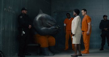 Movie still from “The Suicide Squad” (2021), directed by James Gunn – A group of people standing next to each other in a room; Wide shot, Over the shoulder angle