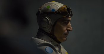 Movie still from “The Suicide Squad” (2021), directed by James Gunn – A man wearing a helmet and goggles; Close Up shot, Low angle