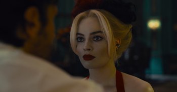 Movie still from “The Suicide Squad” (2021), directed by James Gunn – A person wearing a red dress; Close Up shot, Over the shoulder angle