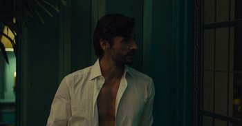 Movie still from “The Suicide Squad” (2021), directed by James Gunn – A man in a white dress shirt is looking to the side; Close Up shot, High angle