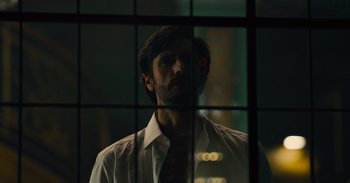 Movie still from “The Suicide Squad” (2021), directed by James Gunn – A man wearing a white dress shirt and a red tie; Close Up shot, Low angle