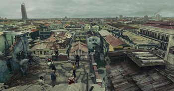 Movie still from “The Suicide Squad” (2021), directed by James Gunn – An aerial view of an urban area with a lot of buildings; Extreme Wide shot, High angle