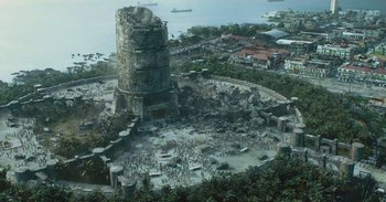 Movie still from “The Suicide Squad” (2021), directed by James Gunn – An aerial view of an abandoned building with a tower; Extreme Wide shot, High angle