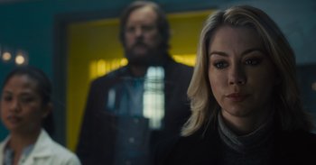 Movie still from “The Suicide Squad” (2021), directed by James Gunn – A woman standing next to a man in a black jacket; Close Up shot, Over the shoulder angle
